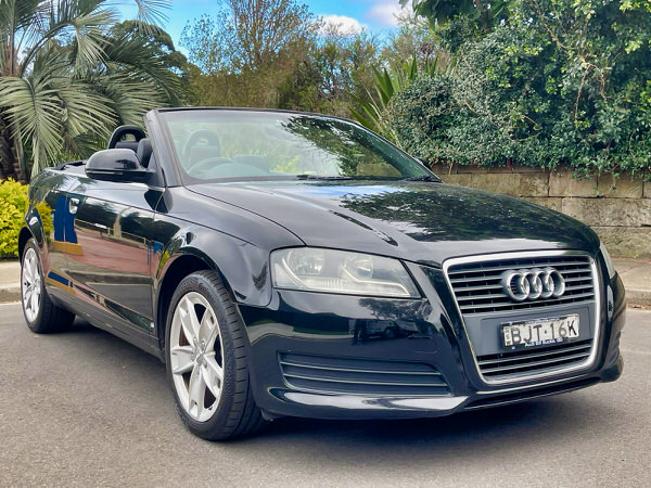Audi A3 for sale – Soft Top Convertible 2009 Model in Black – Photo showing the view with the soft top roof down from the front driver side angle view