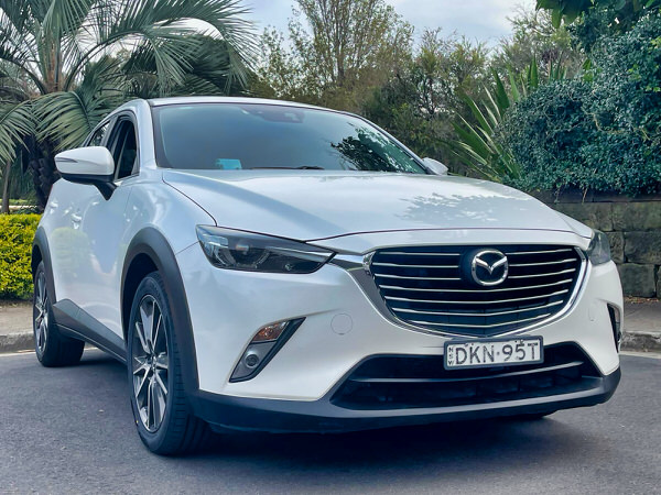 Used Mazda for sale - Automatic CX3 Sports 2016 SUV Model in White - photo showing a close up of the front driver side angle view showing the colour coded matching bumpers and front grille