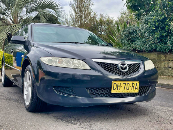Used Mazda for sale - Mazda 6 2004 model in Black with great customer reviews - photo of front drivers side view with colour matching front bumper and grille