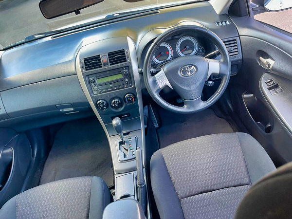 Used Toyota Corolla for sale - Model shown is a light blue 2010 Automatic Corolla with low kms in great condition - Photo showing the view from the driver seat looking out of the windscreen