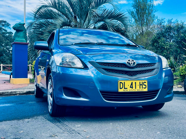 Used Toyota Yaris for sale - Automatic 2007 model - Photo showing the front driver side angle view showing the colour matching front bumper and grille