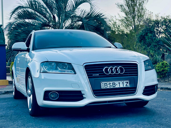 Used Audi A3 for sale in Sydney - Automatic white 2.0T Quattro - all wheel drive full leather Sports back Model - photo showing the front straight on view with colour matching front bumper and black and chrome grille