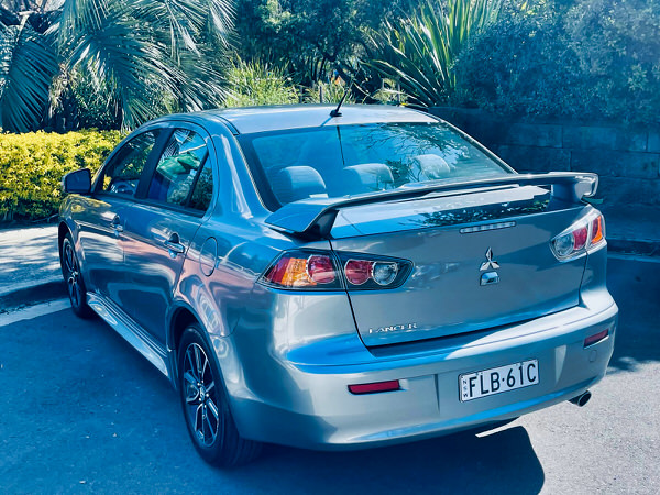 Used Mitsubishi for sale - 2017 Automatic LANCER ES SPORT 2.0L Model with low kms and service history - Photo shows the rear passenger side angle view showing the rear body kit and spoiler in the same colour as the vehicle