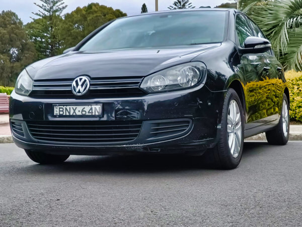 Used Golf for sale - 2010 Automatic TSI Engine model in Black - photo shows the front passenger side angle view with matching black front grille and bumper