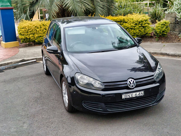 Used Golf for sale - 2010 Automatic TSI Engine model in Black - photo shows the front driver side angle view with matching black front grille and bumper